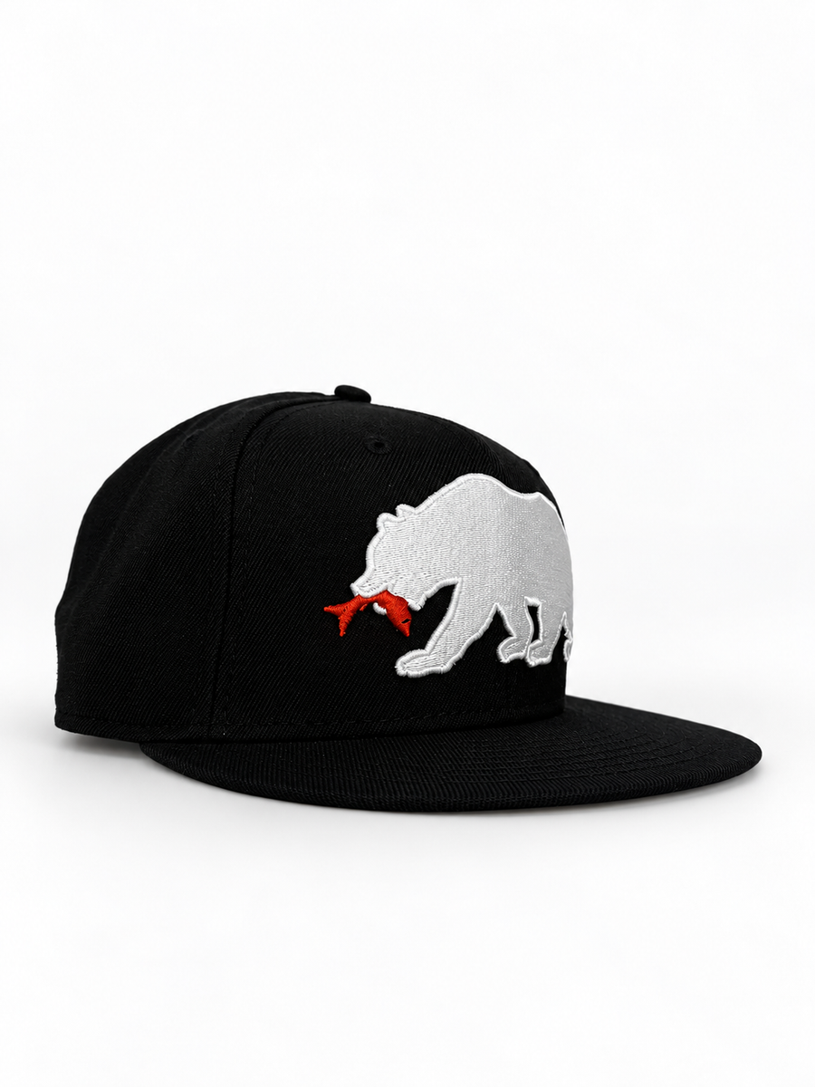 CaliBear and Salmon black fitted hat with white bear and orange fish — three-quarter view