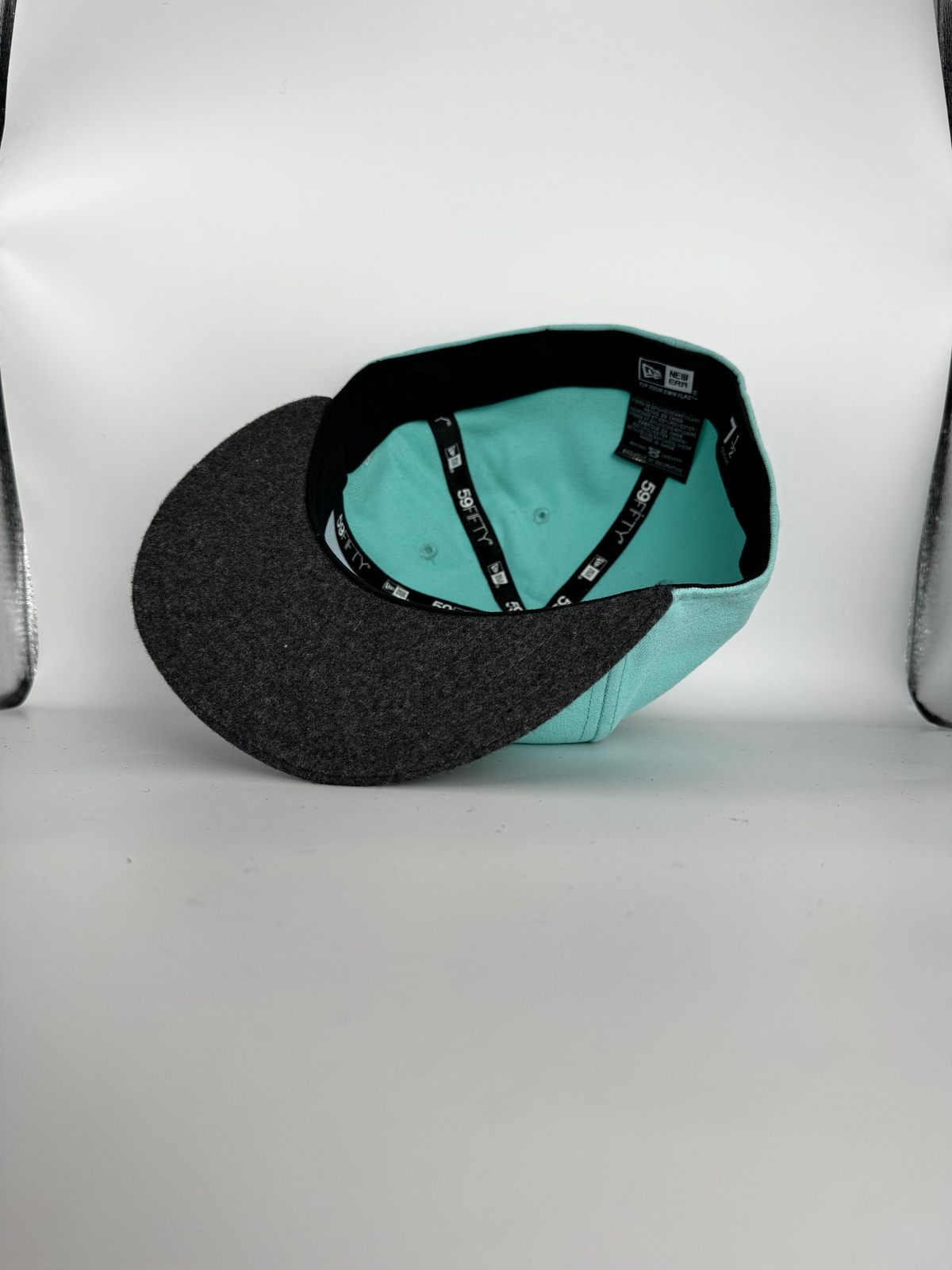 Baby blue CaliBear New Era fitted with black bear and white fish — interior original