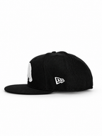 CaliBear and Salmon black fitted hat with white bear and orange fish — New Era side view