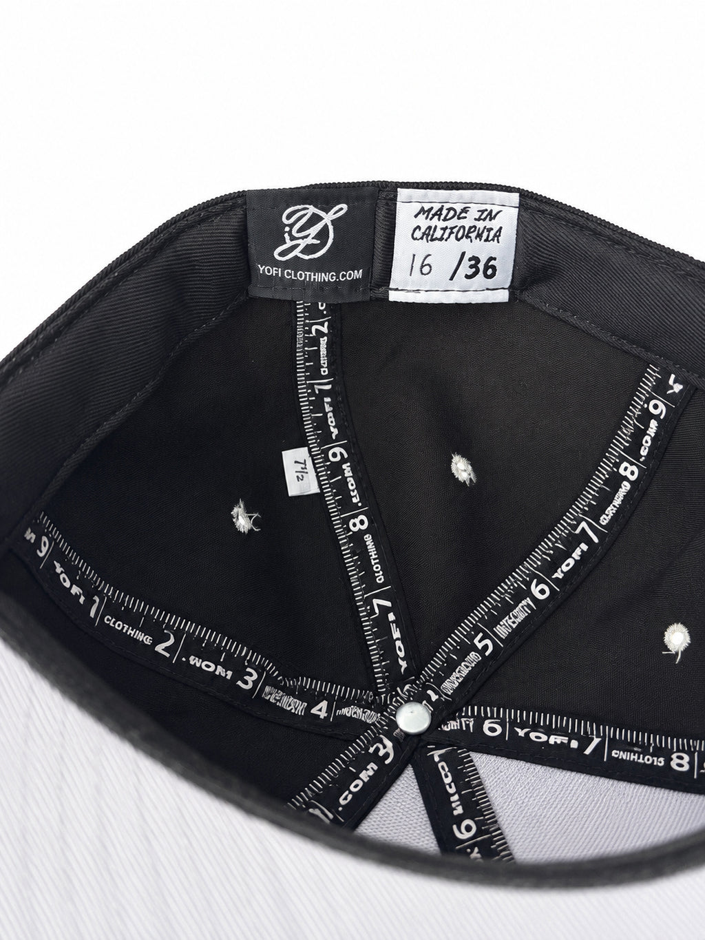 Black corduroy fitted Yofi hat with white embroidery, numbered label view