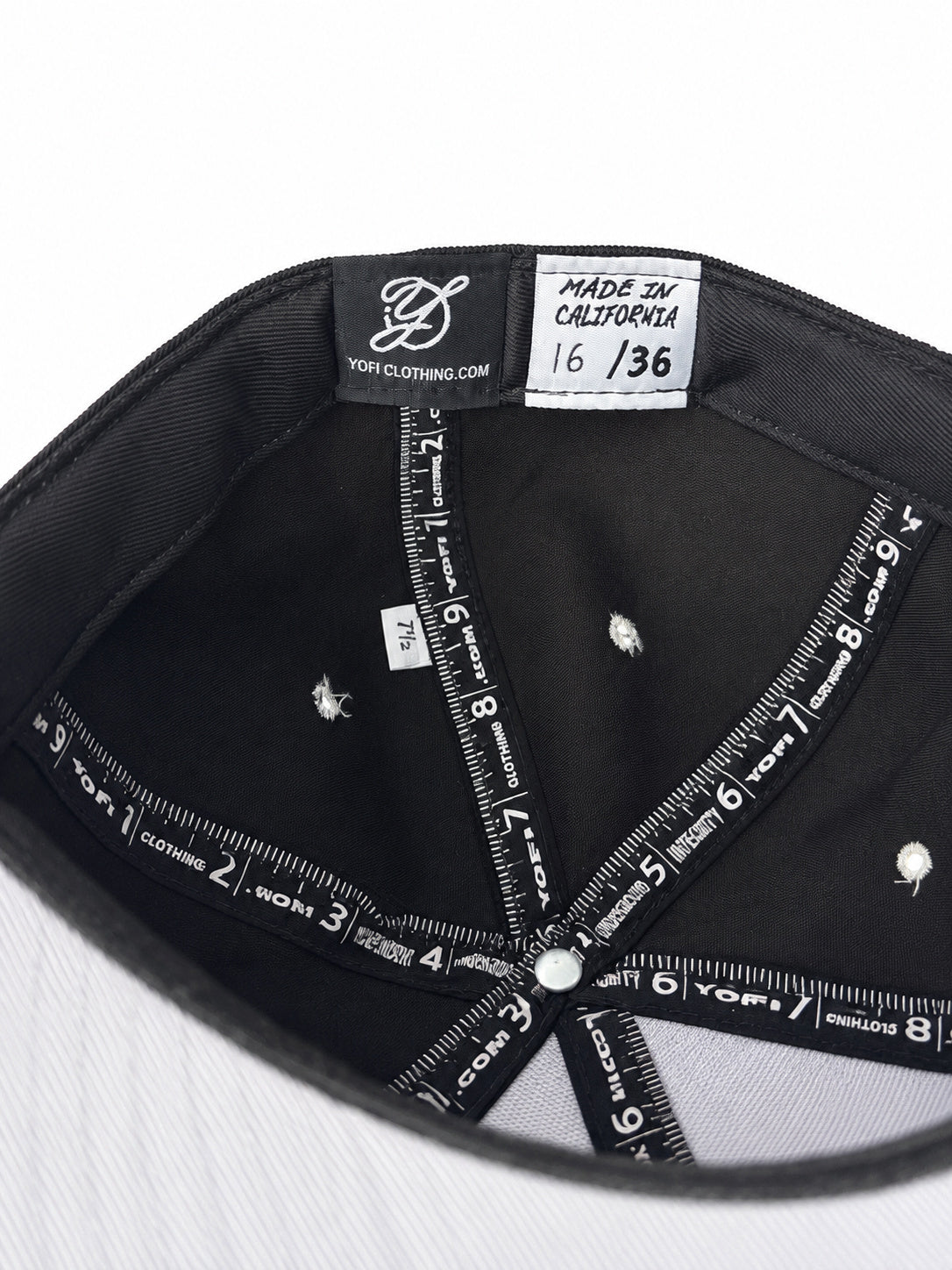 Black corduroy fitted Yofi hat with white embroidery, numbered label view